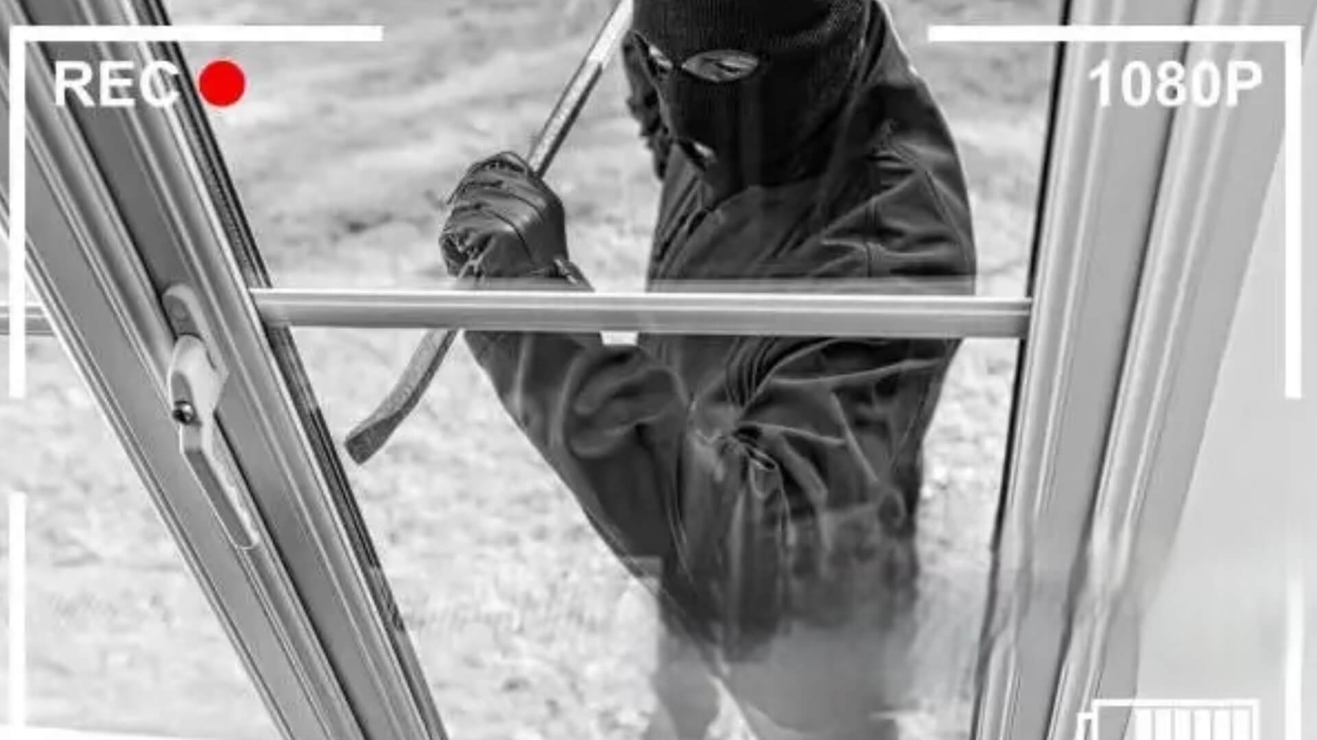 cctv footage of a burglar trying to brake through the front door